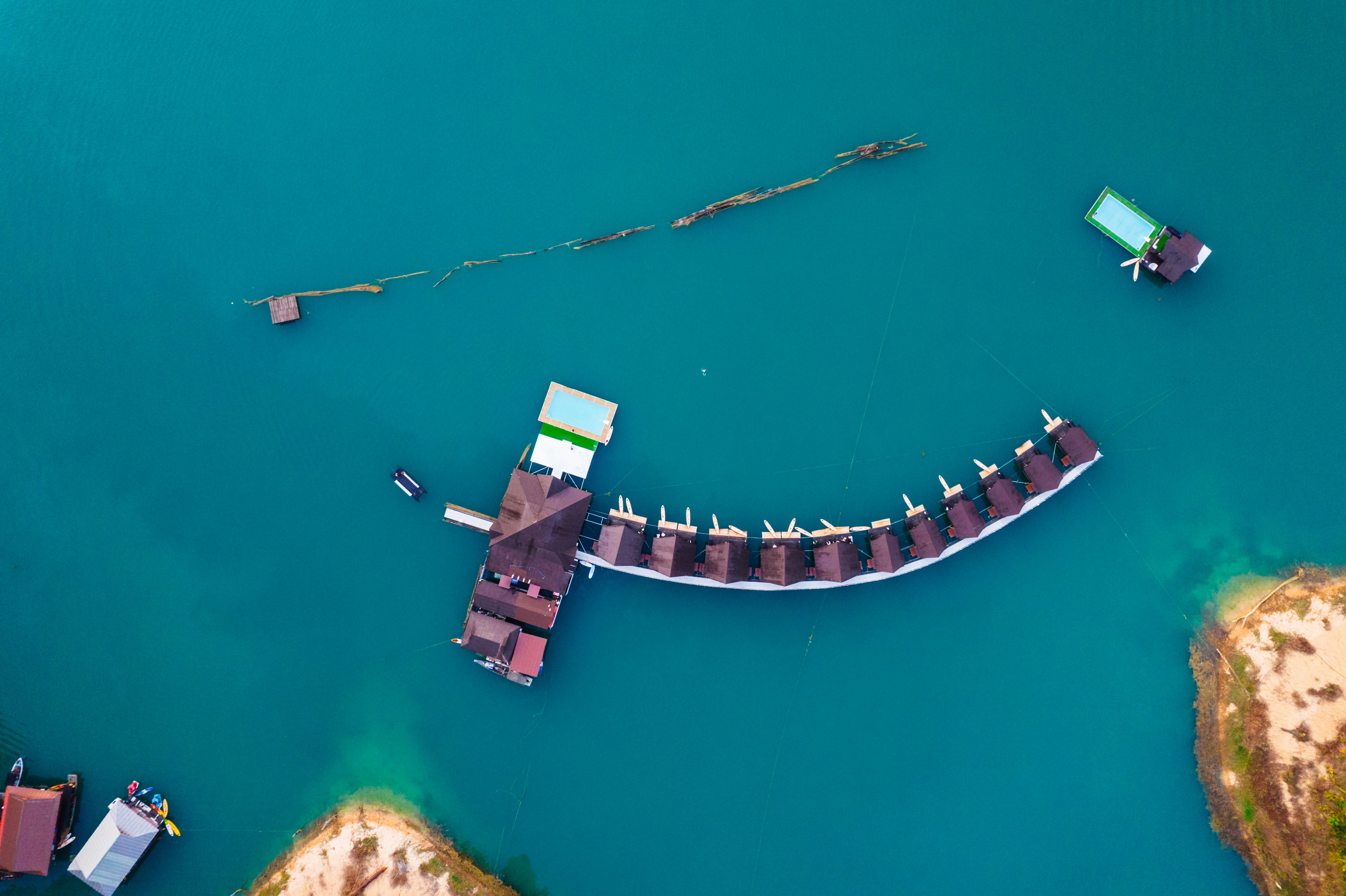 An aerial view of a pier in the middle of a body of water