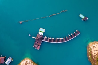 An aerial view of a pier in the middle of a body of water