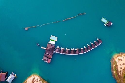 An aerial view of a pier in the middle of a body of water