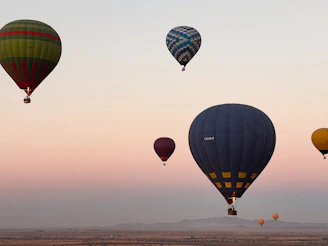 A group of hot air balloons flying in the sky