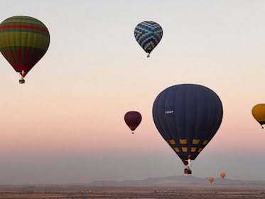 A group of hot air balloons flying in the sky