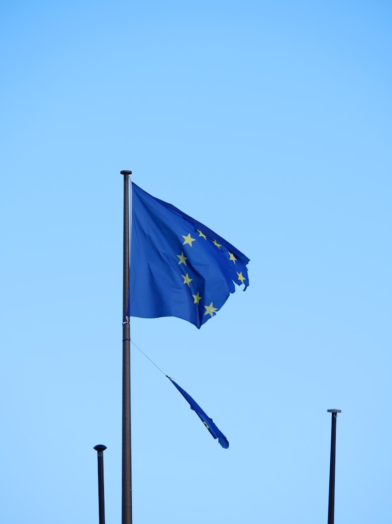 European Union flag flying in the wind against a blue sky