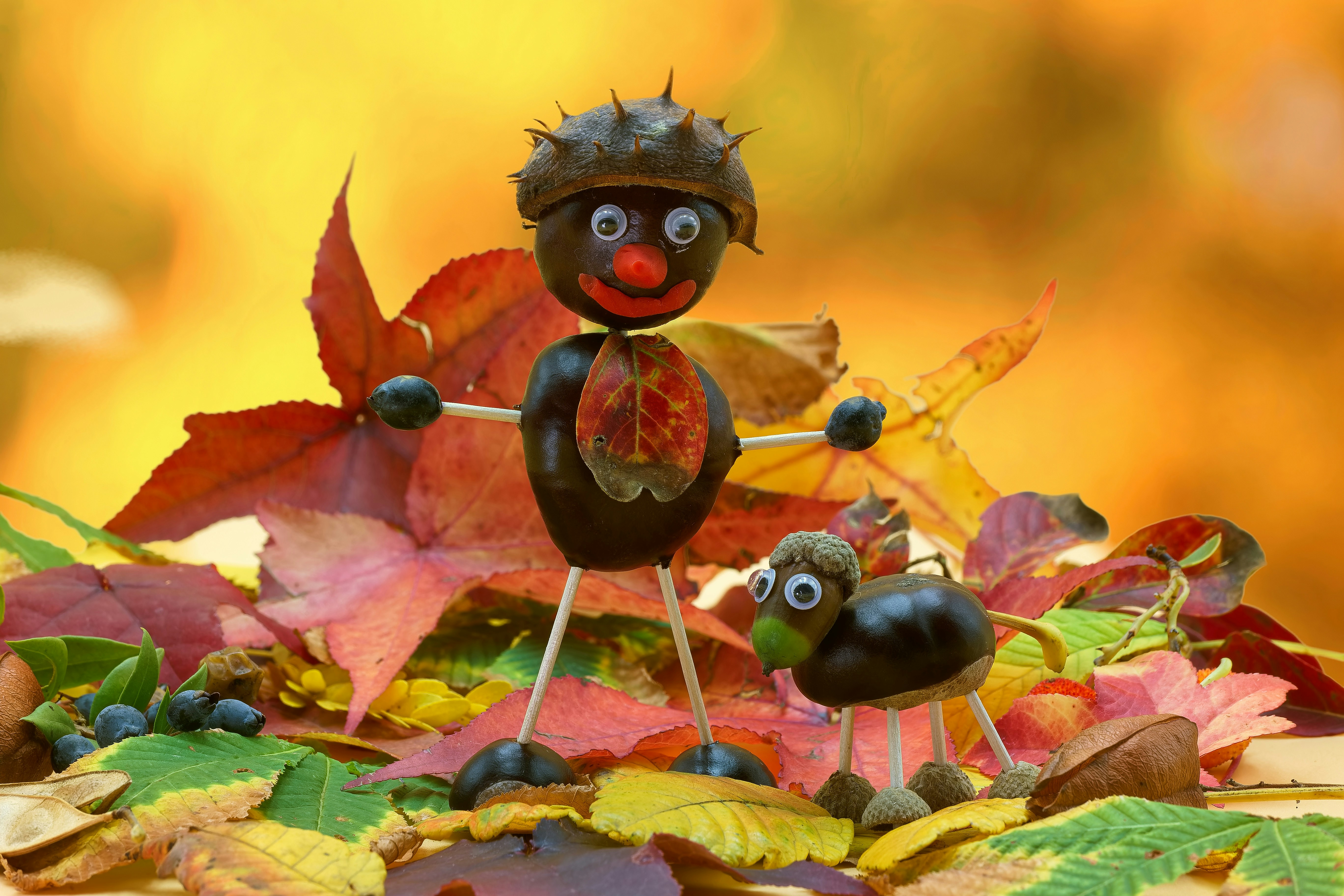 A small figurine of a scarecrow with two smaller figurines