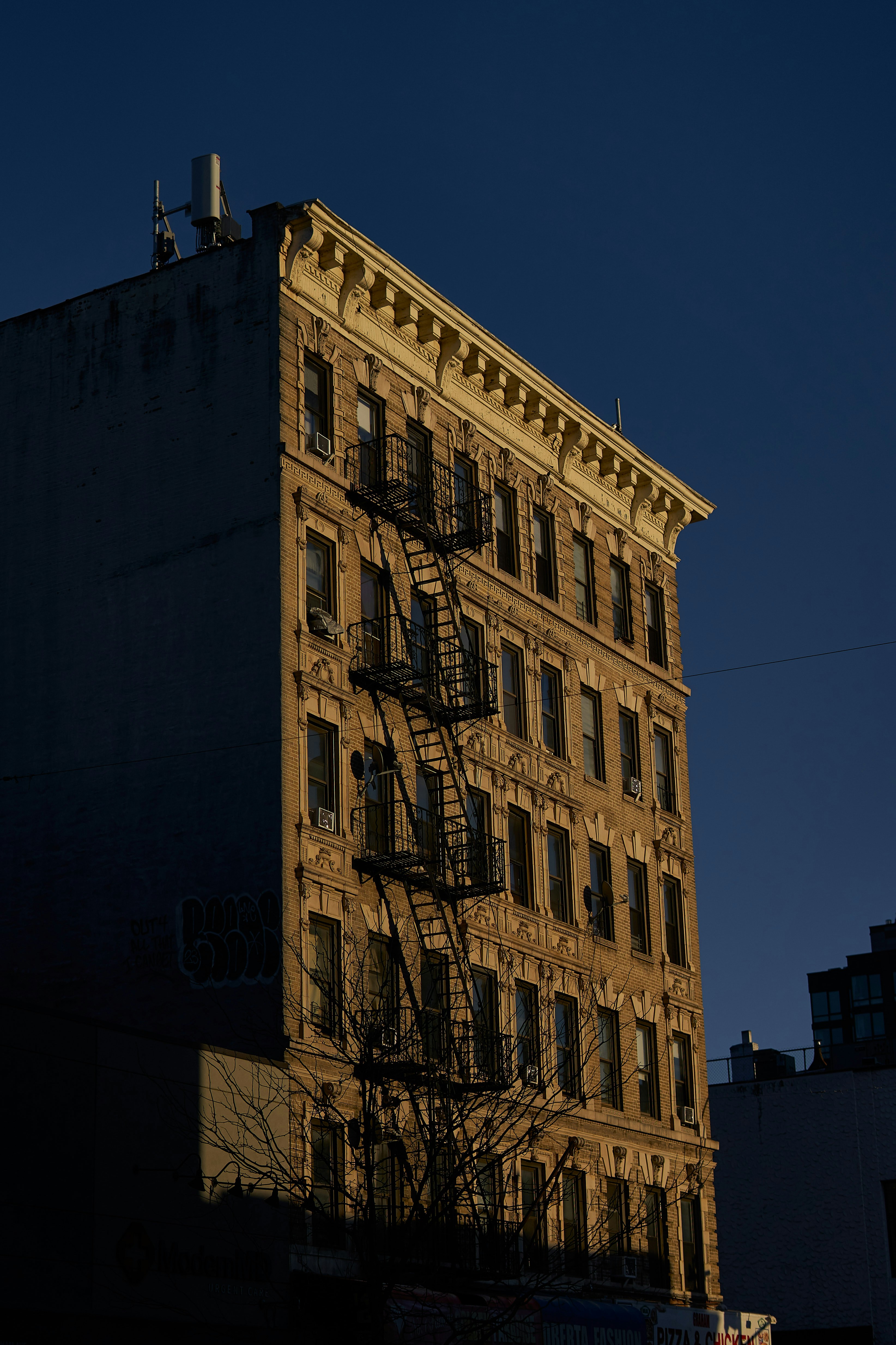 A tall building with a fire escape on the top of it