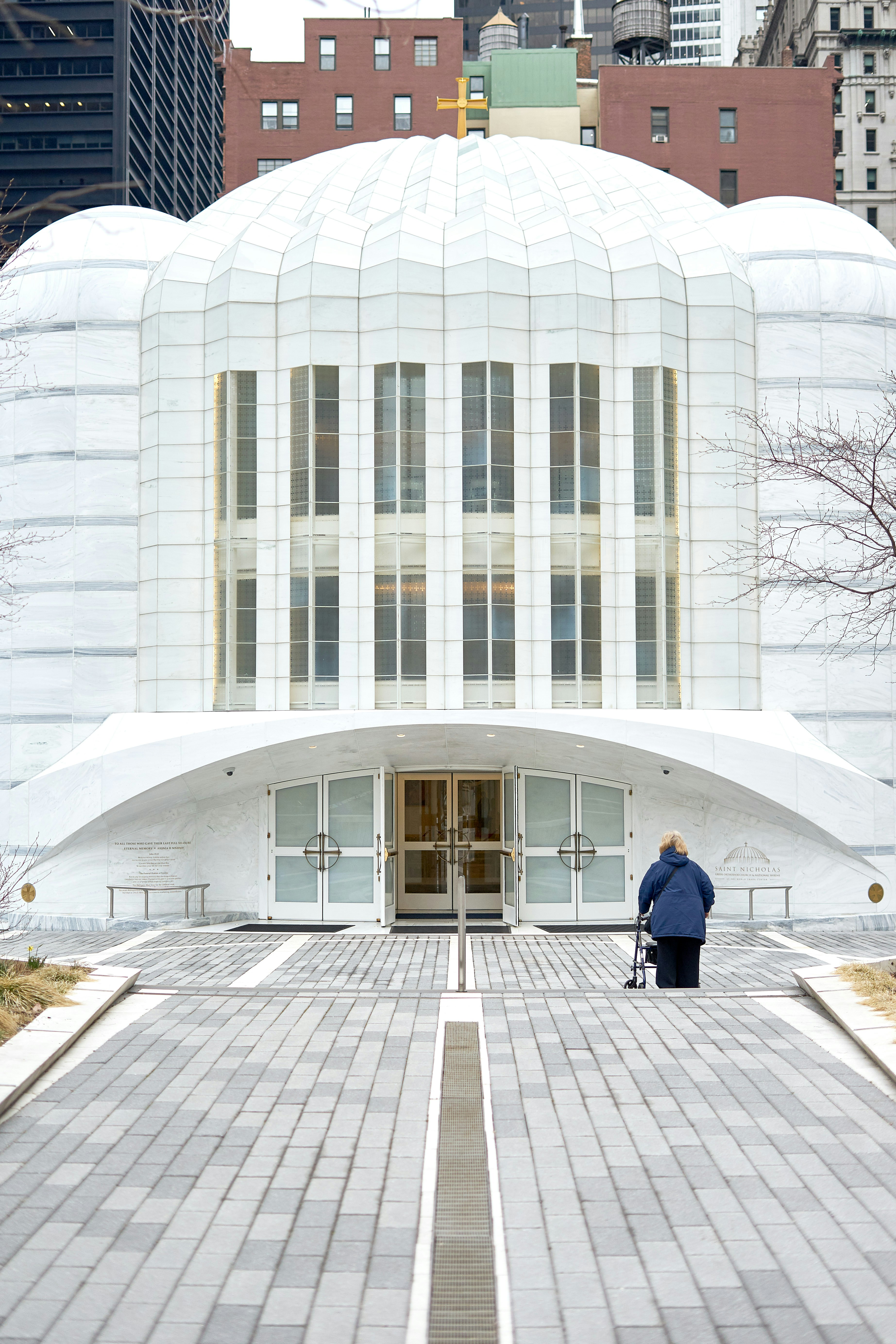 A man standing in front of a white building