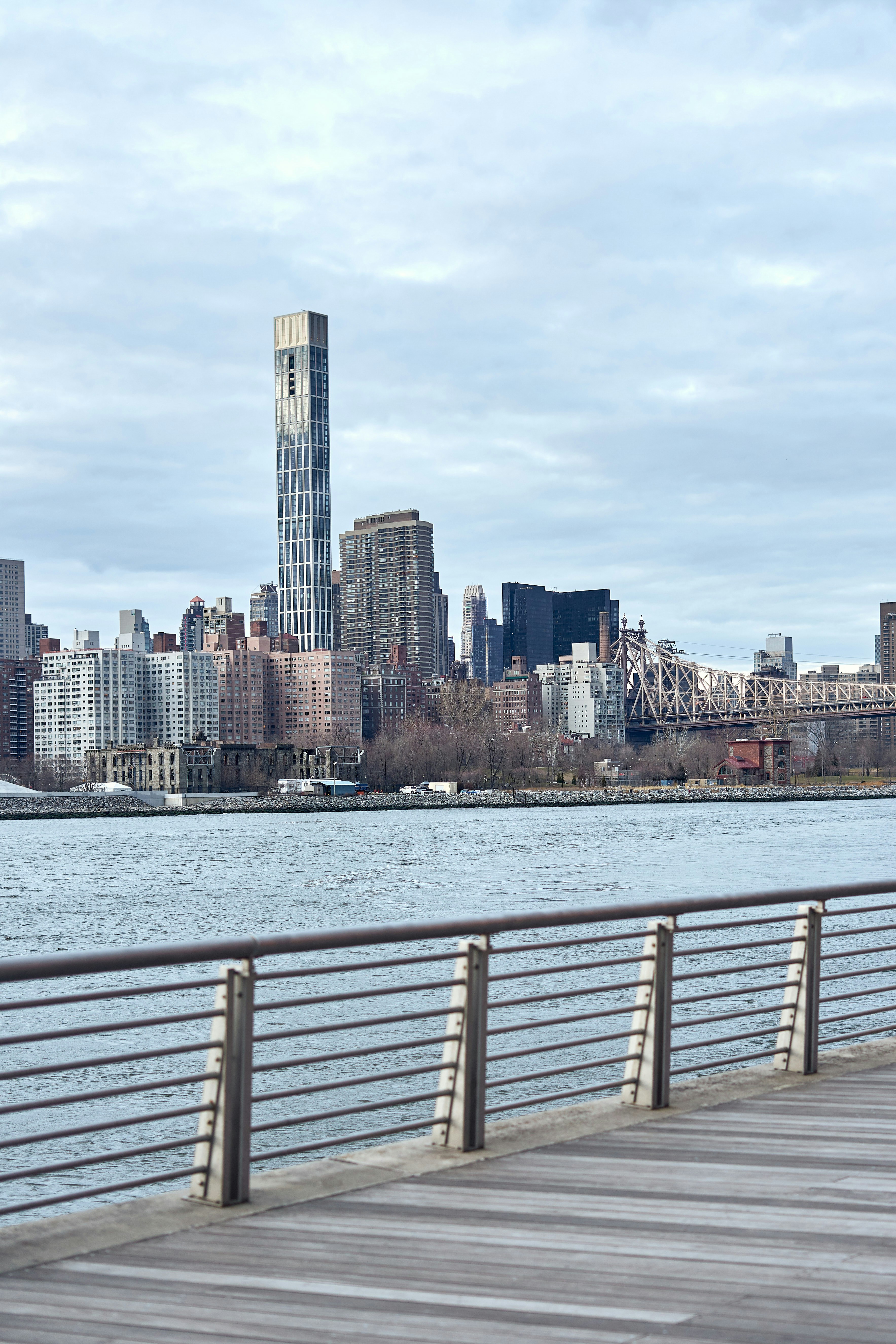 A man riding a skateboard on top of a wooden pier