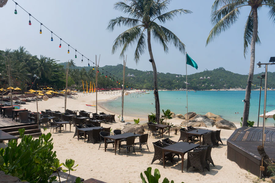 Tables and umbrellas set out on the sand at a Koh Phangan beach