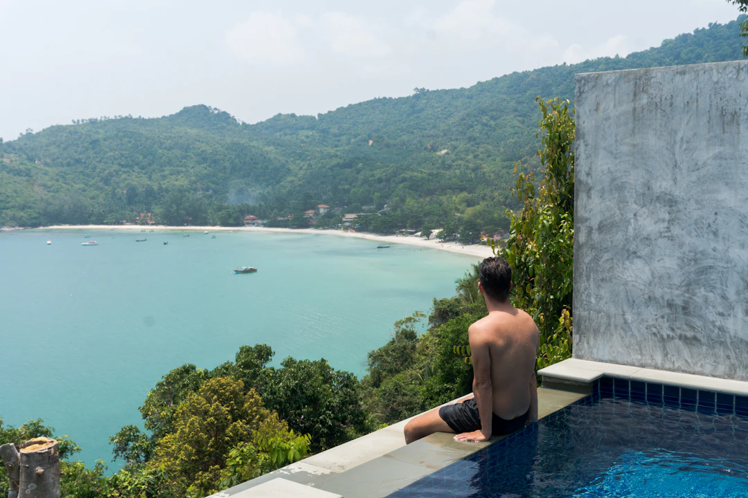 man relaxing on the edge of a pool