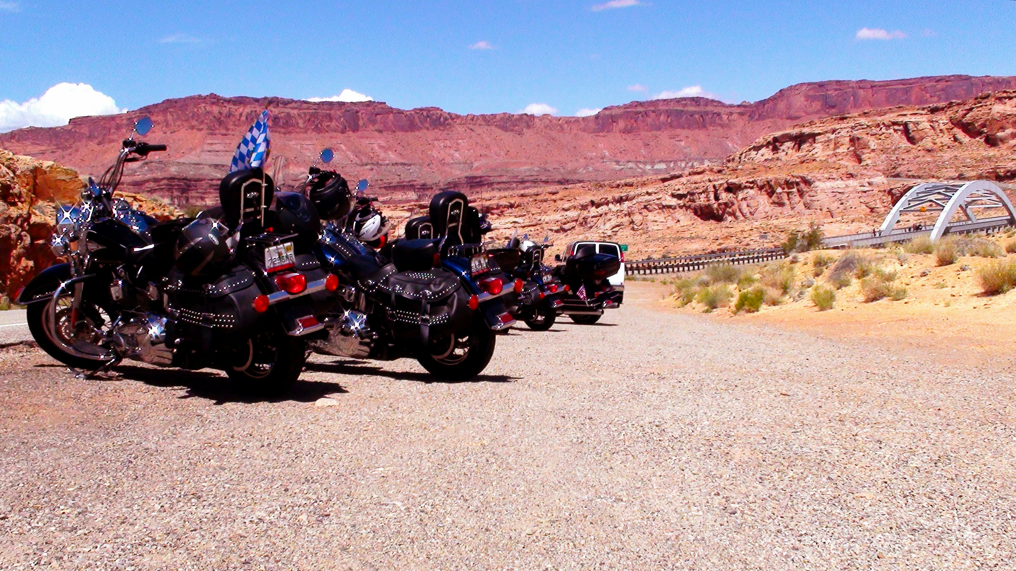 A group of motorcycles parked on the side of a road