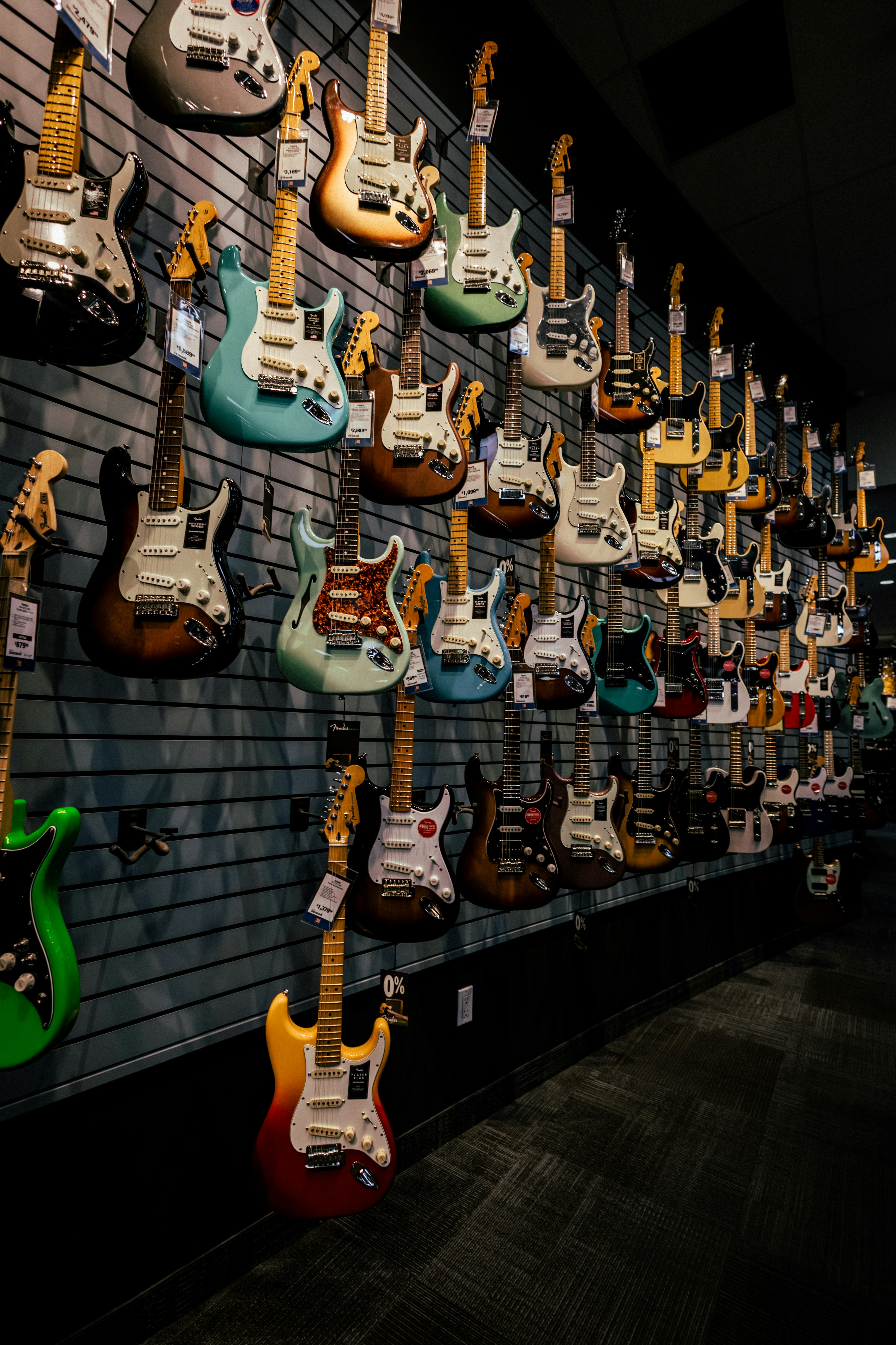 Beginner inspecting a used bass guitar before purchase