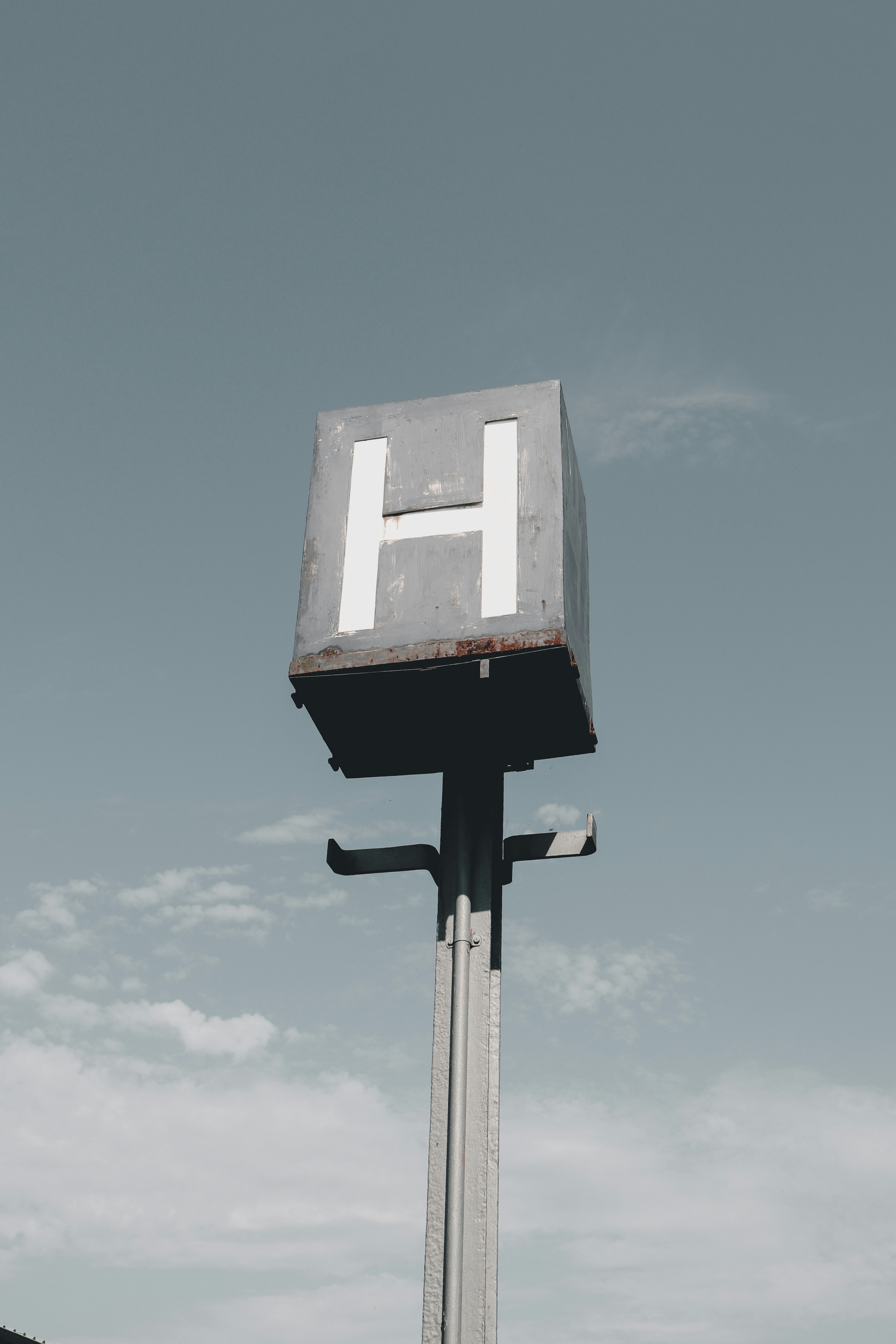 A tall metal pole with a sign on top of it