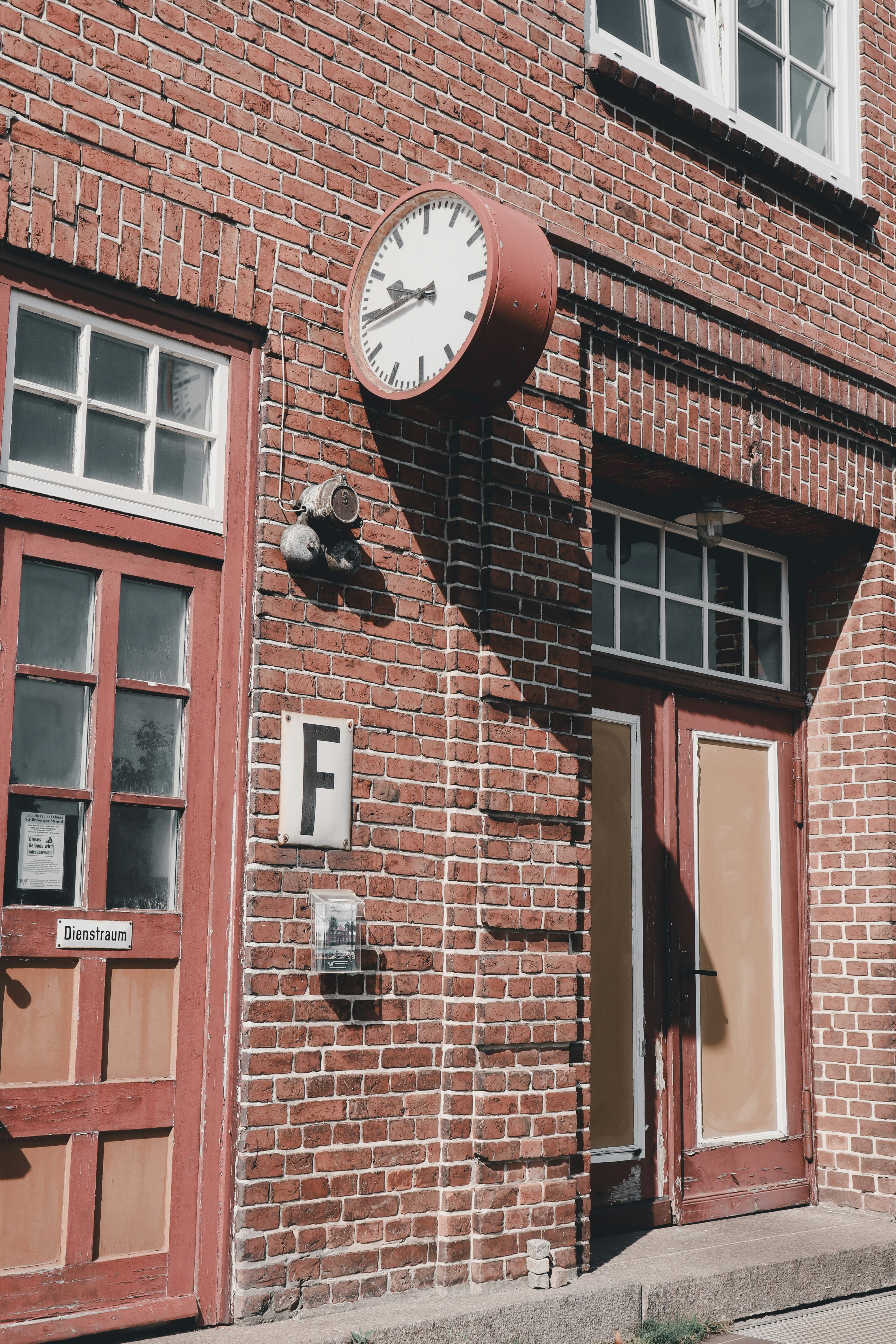 A red brick building with a clock on the side of it