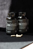 Two bottles of saw palmetto sitting on a table