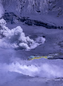 A large plume of smoke coming out of a mountain