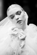 A black and white photo of a woman in a wedding dress