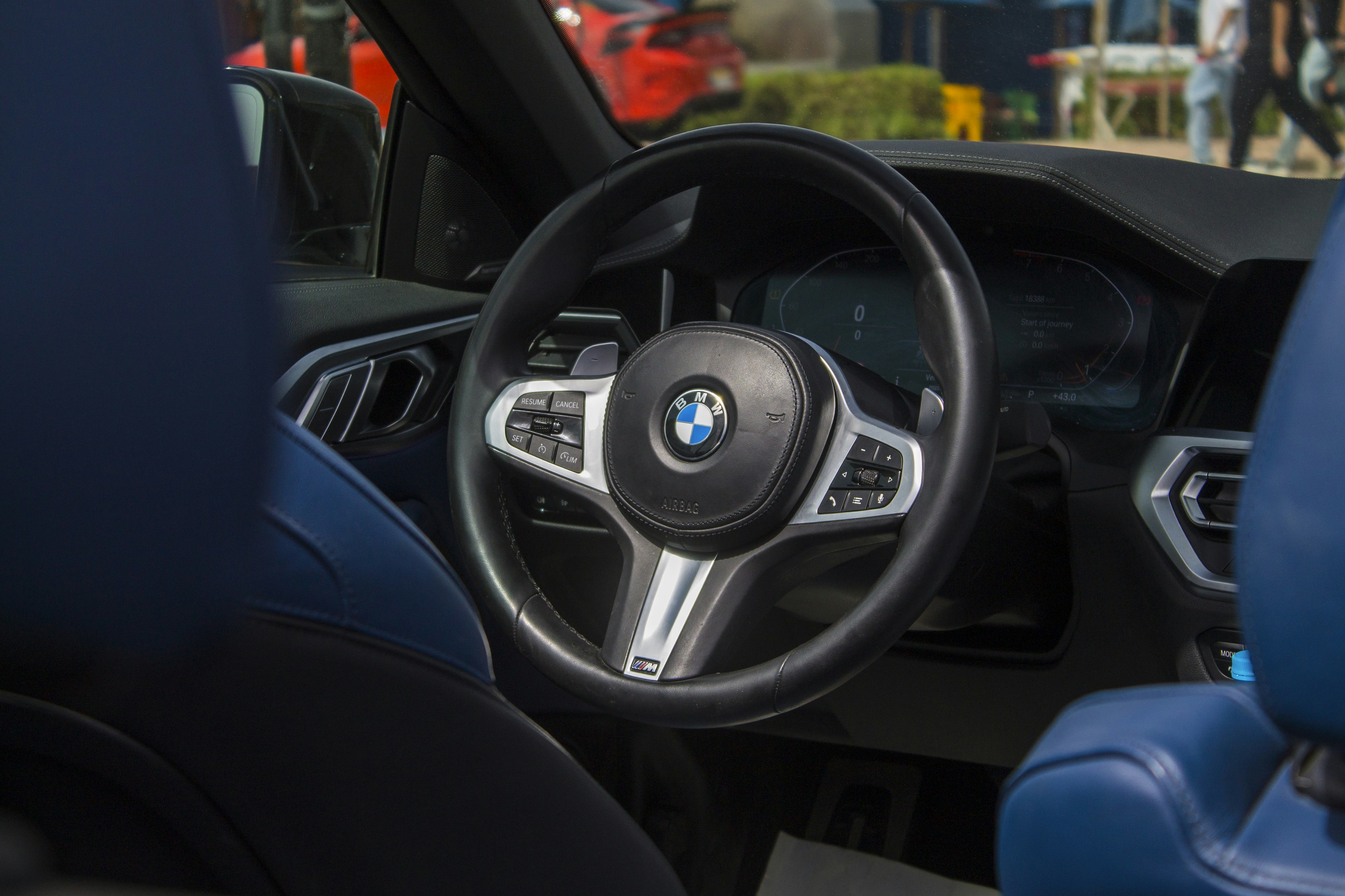 BMW i4 electric car driving through a modern city street