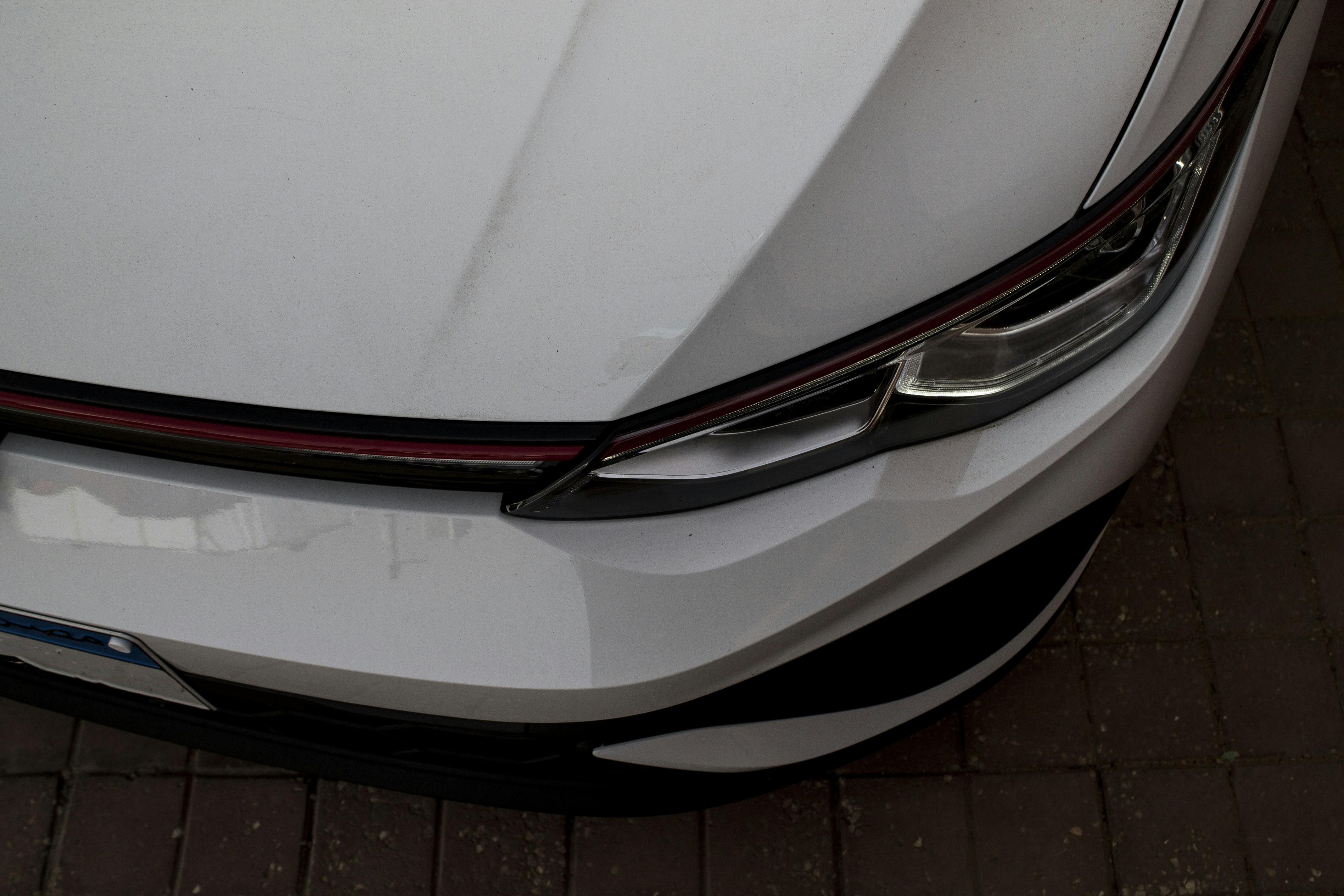 Damaged Tesla Model Y front bumper awaiting repair in a body shop