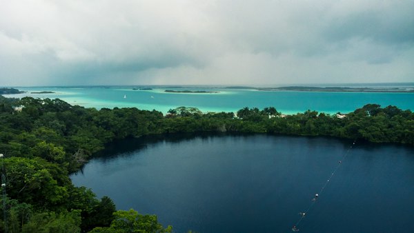 A large body of water surrounded by trees — Bacalar, Mexico