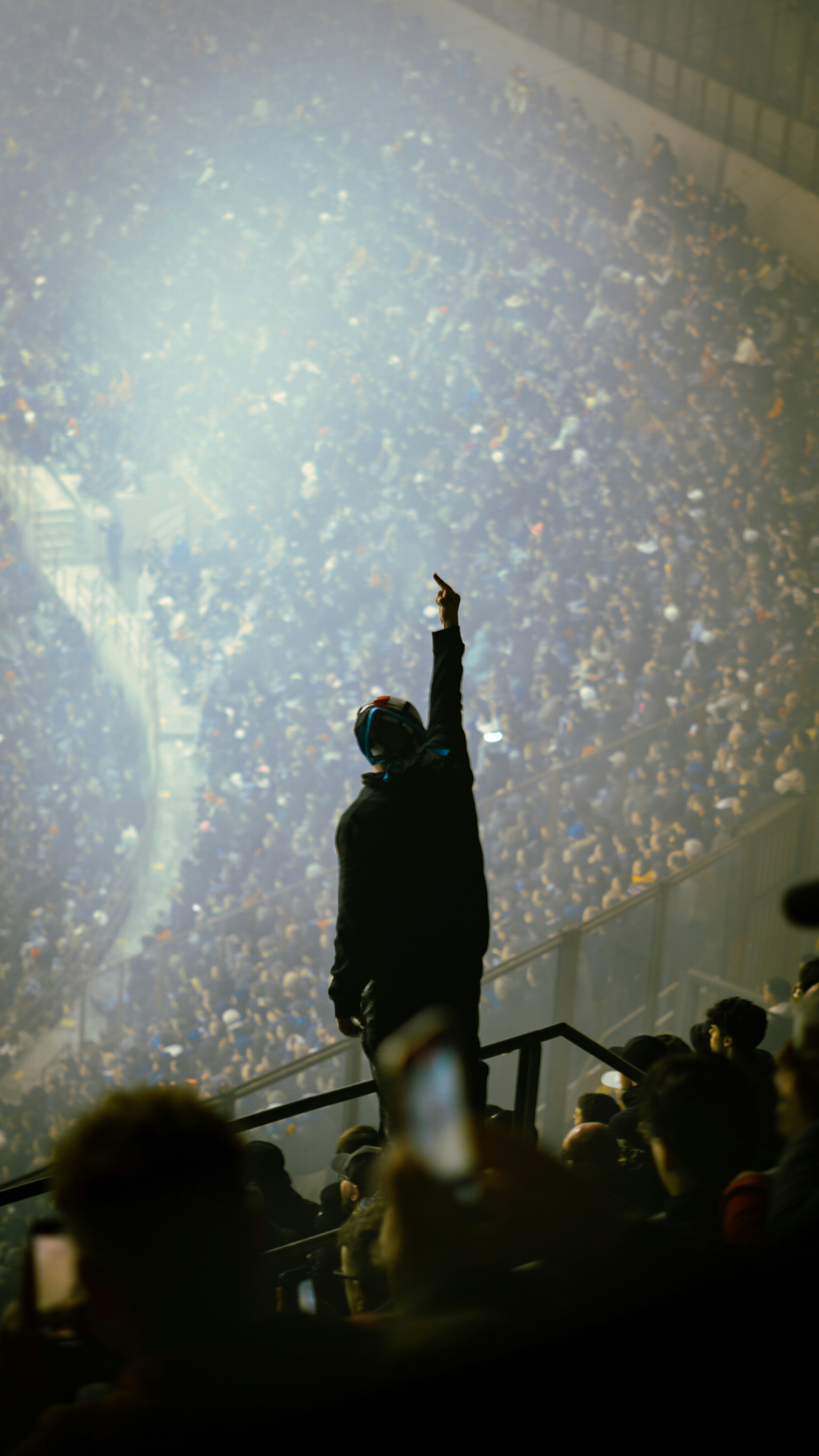 A man standing in front of a crowd at a concert
