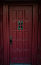 A red door with a green glass window