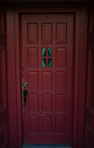 A red door with a green glass window