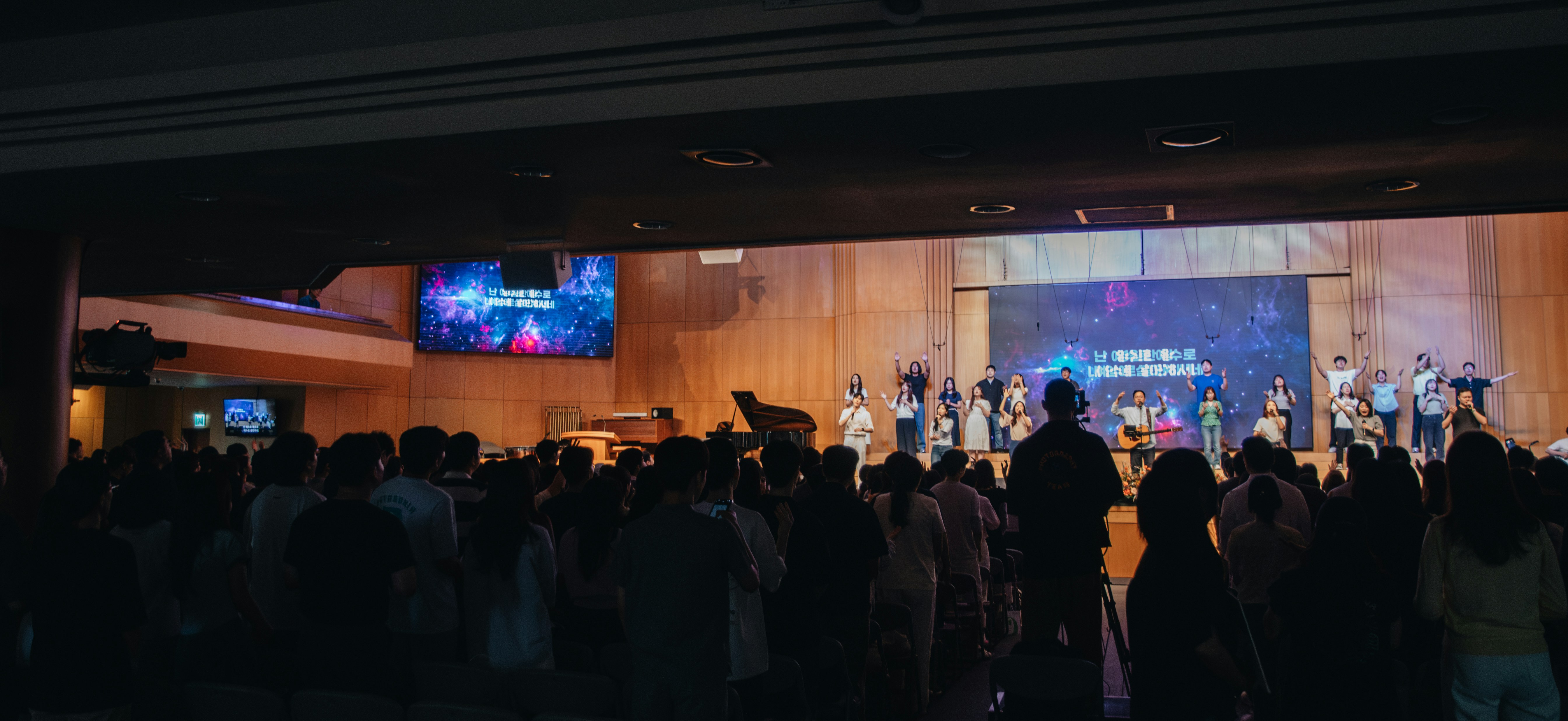 A crowd of people standing in front of a stage