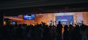 A crowd of people standing in front of a stage