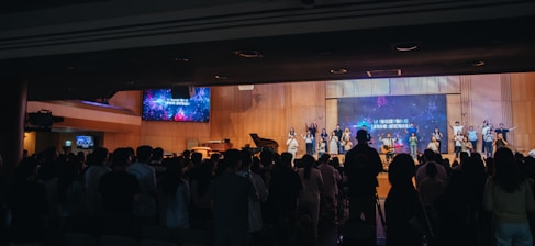 A crowd of people standing in front of a stage
