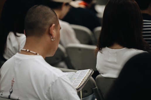 A group of people sitting next to each other