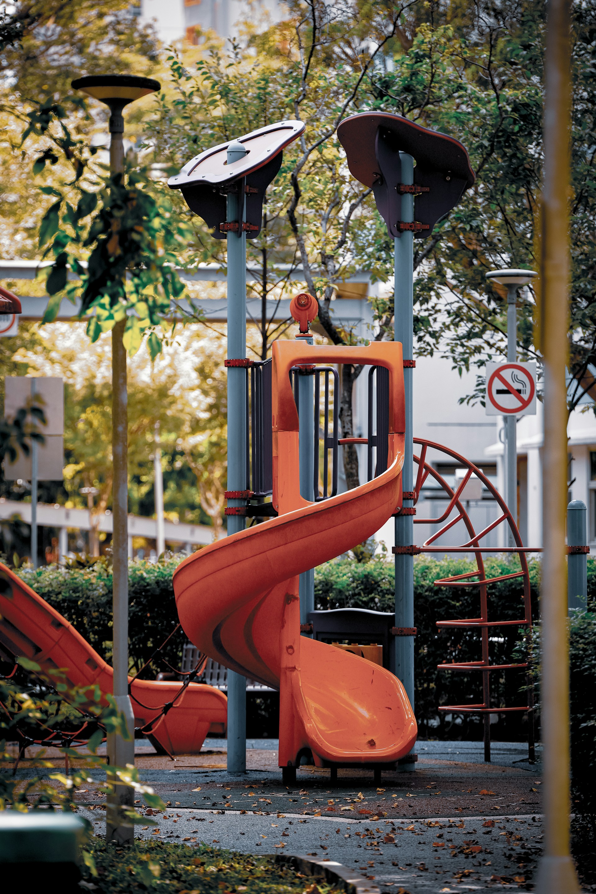 A children's play area with a slide and a basketball hoop