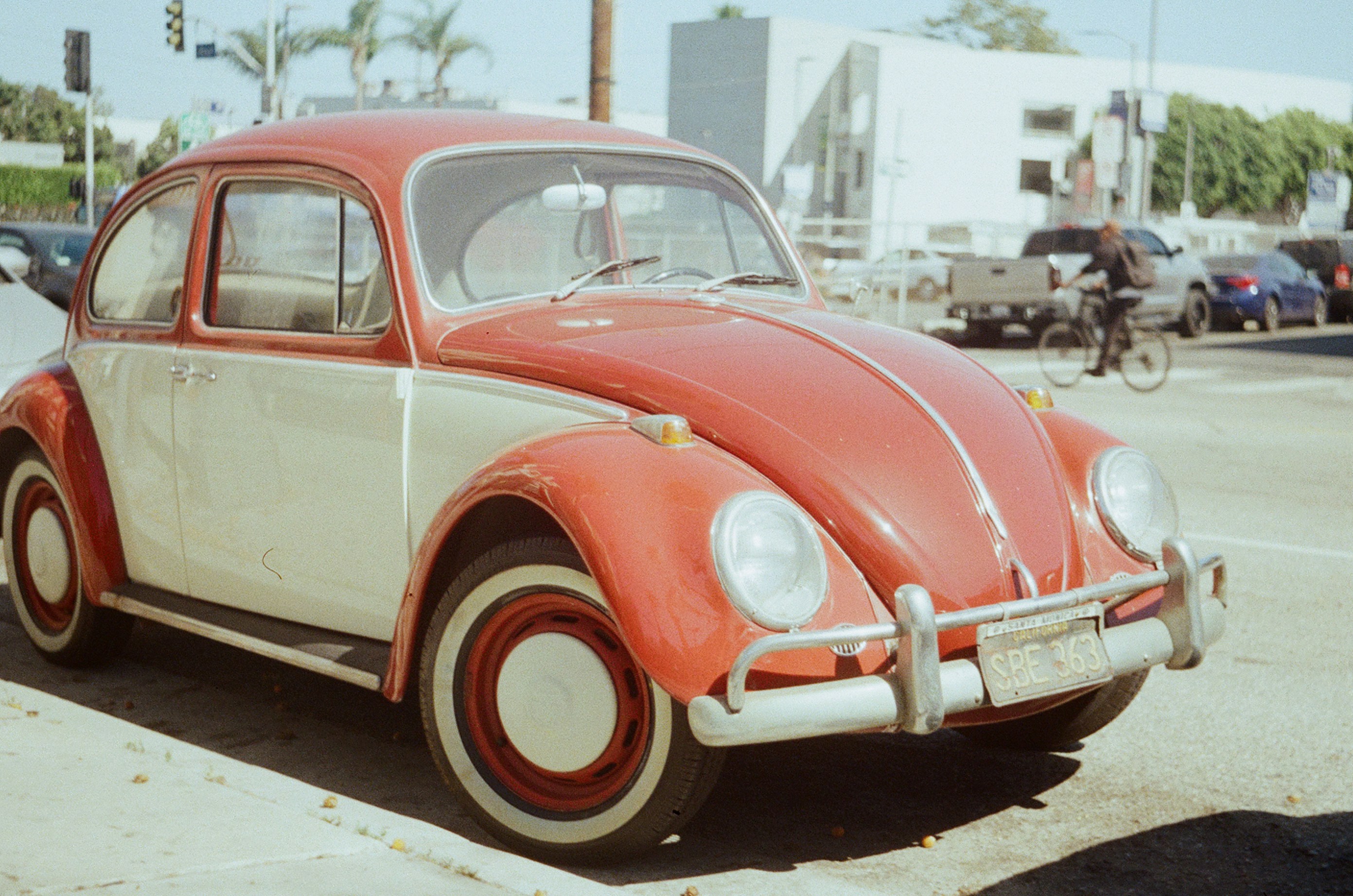 A red and white car parked on the side of the road