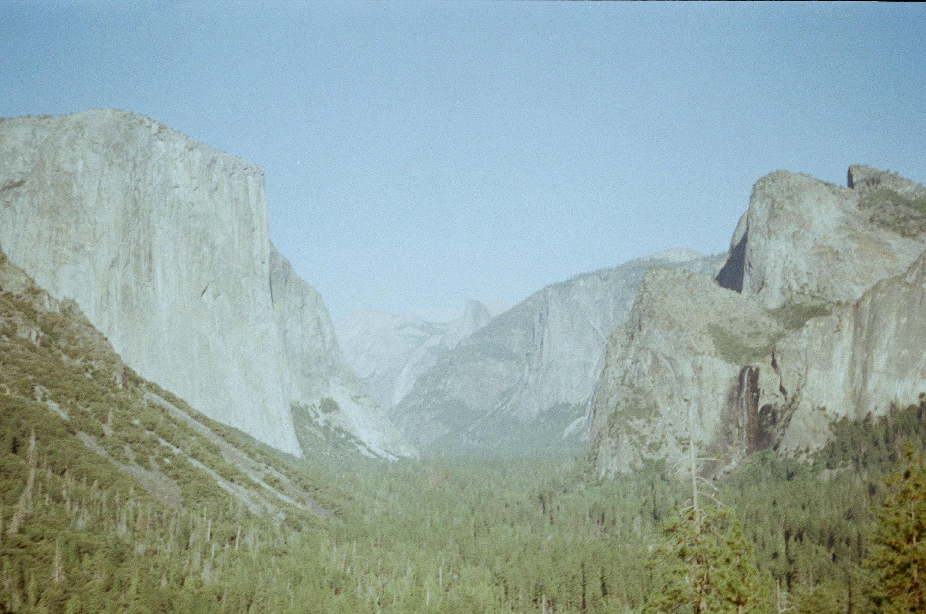 A view of a valley with mountains in the background