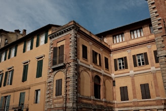 A large building with a clock tower in front of it