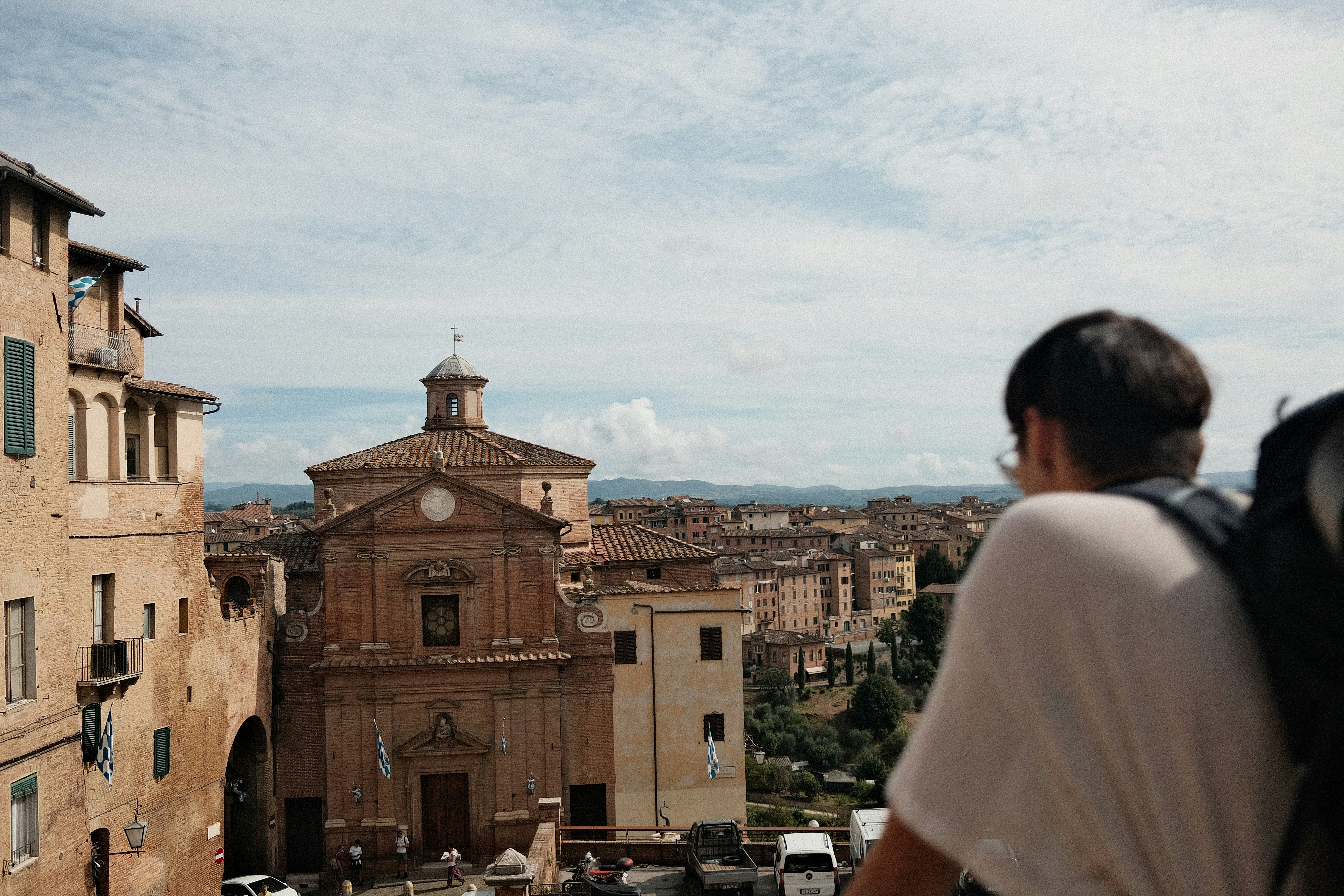 A man with a backpack looking out over a city