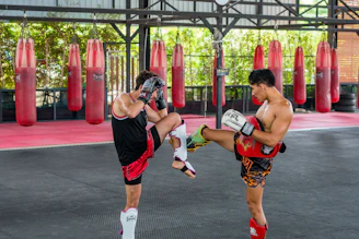 A couple of men standing next to each other in a gym