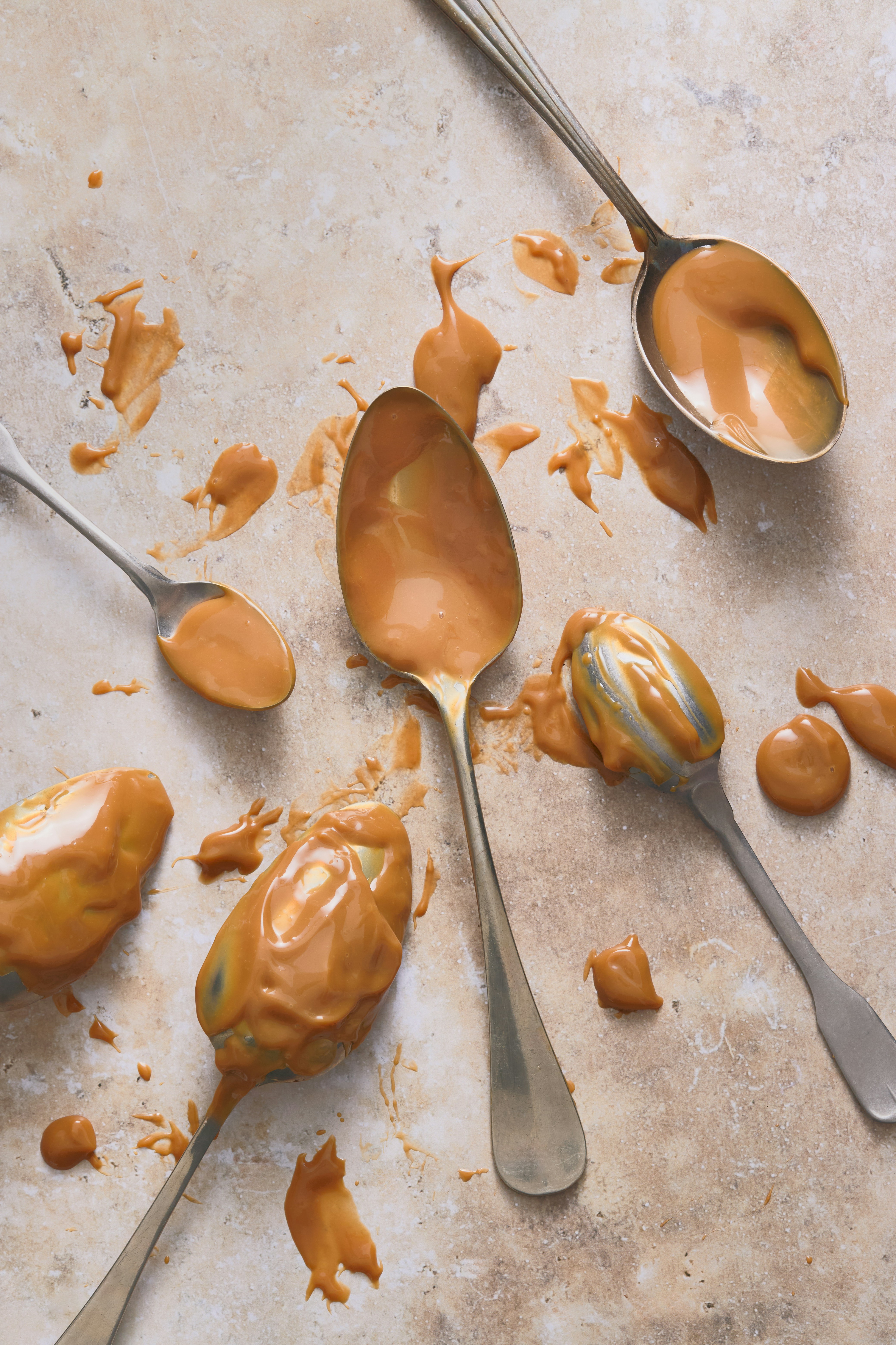 Spoons filled with peanut butter on a table