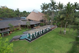 An aerial view of a resort with a swimming pool