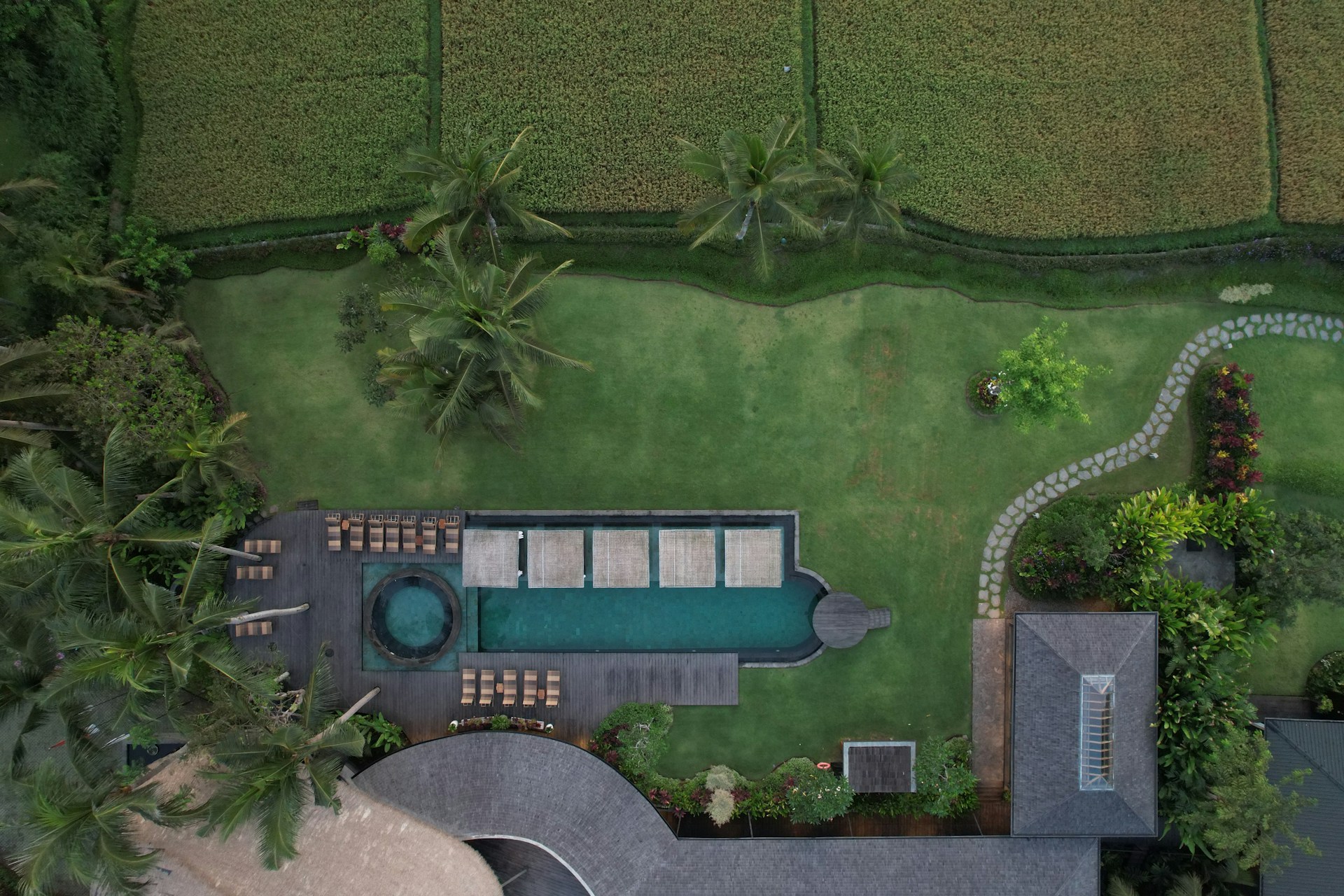 An aerial view of a house with a swimming pool
