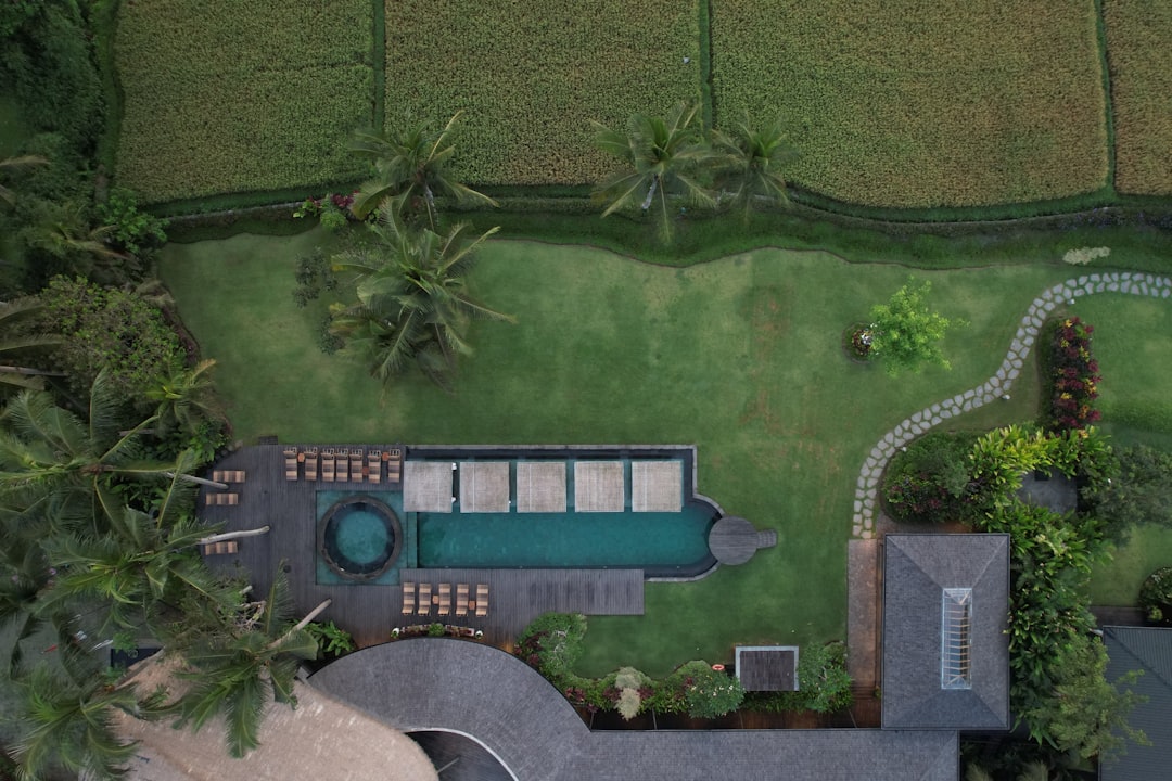 An aerial view of a house with a swimming pool,