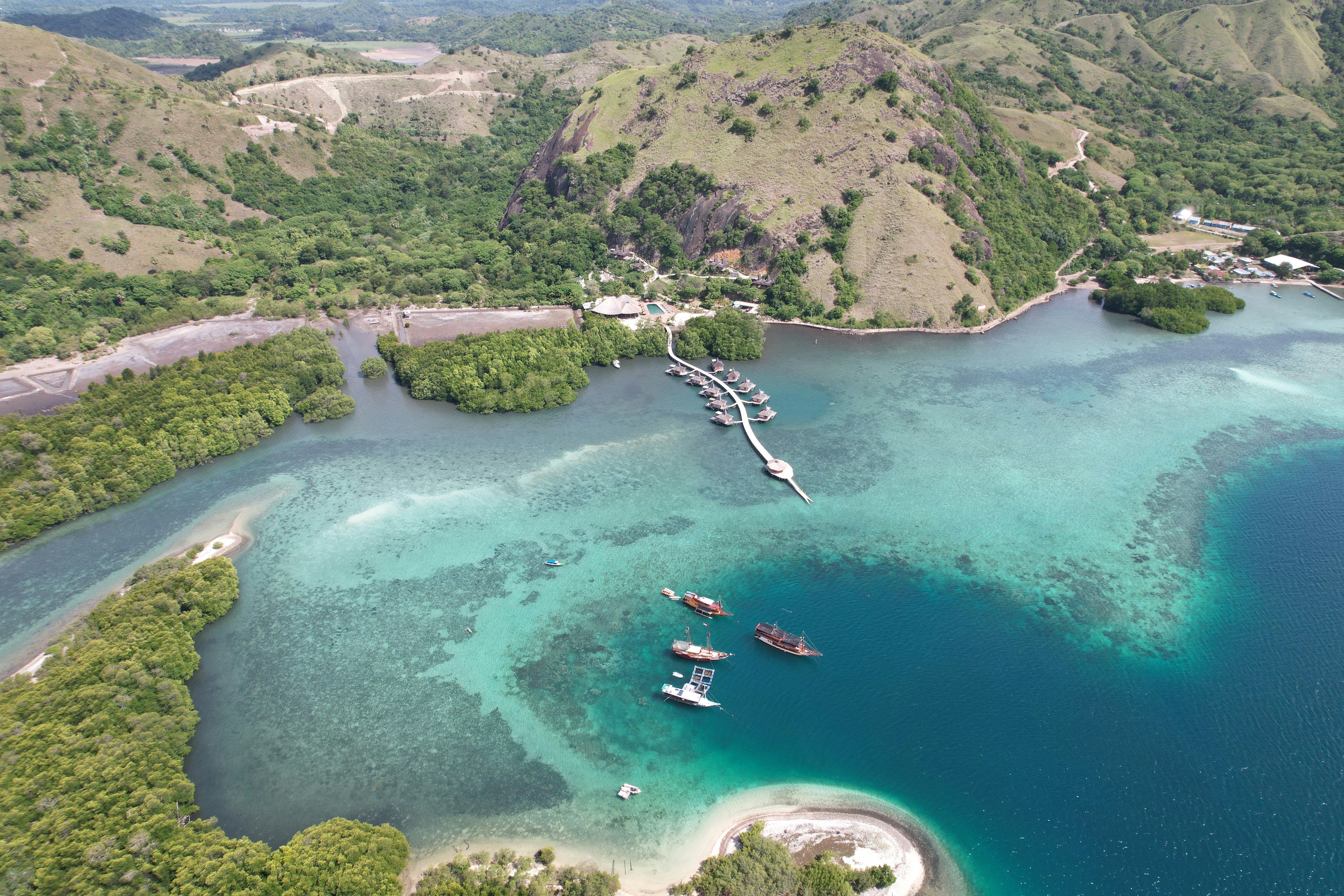 A large body of water surrounded by lush green hills