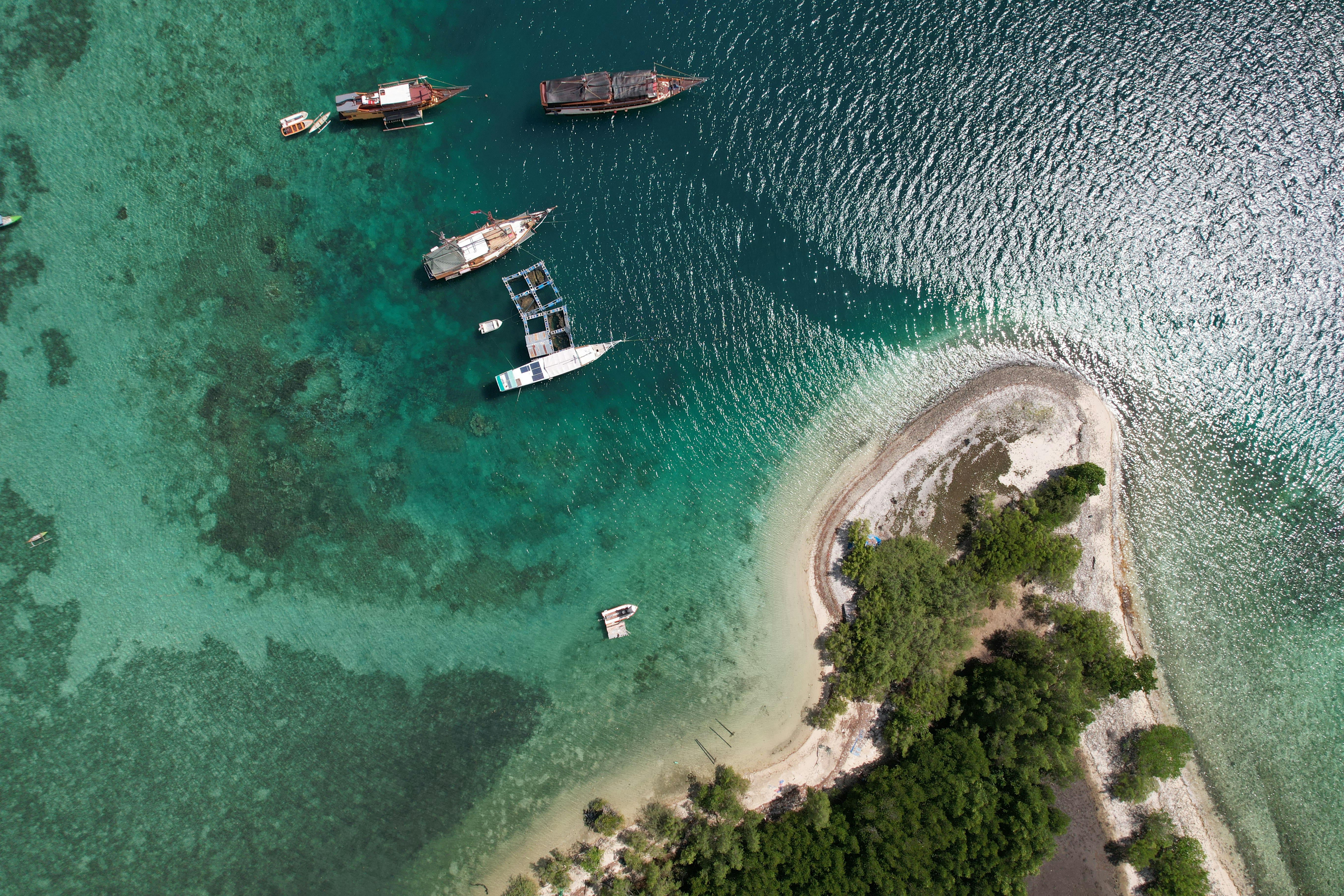 A group of boats floating on top of a body of water