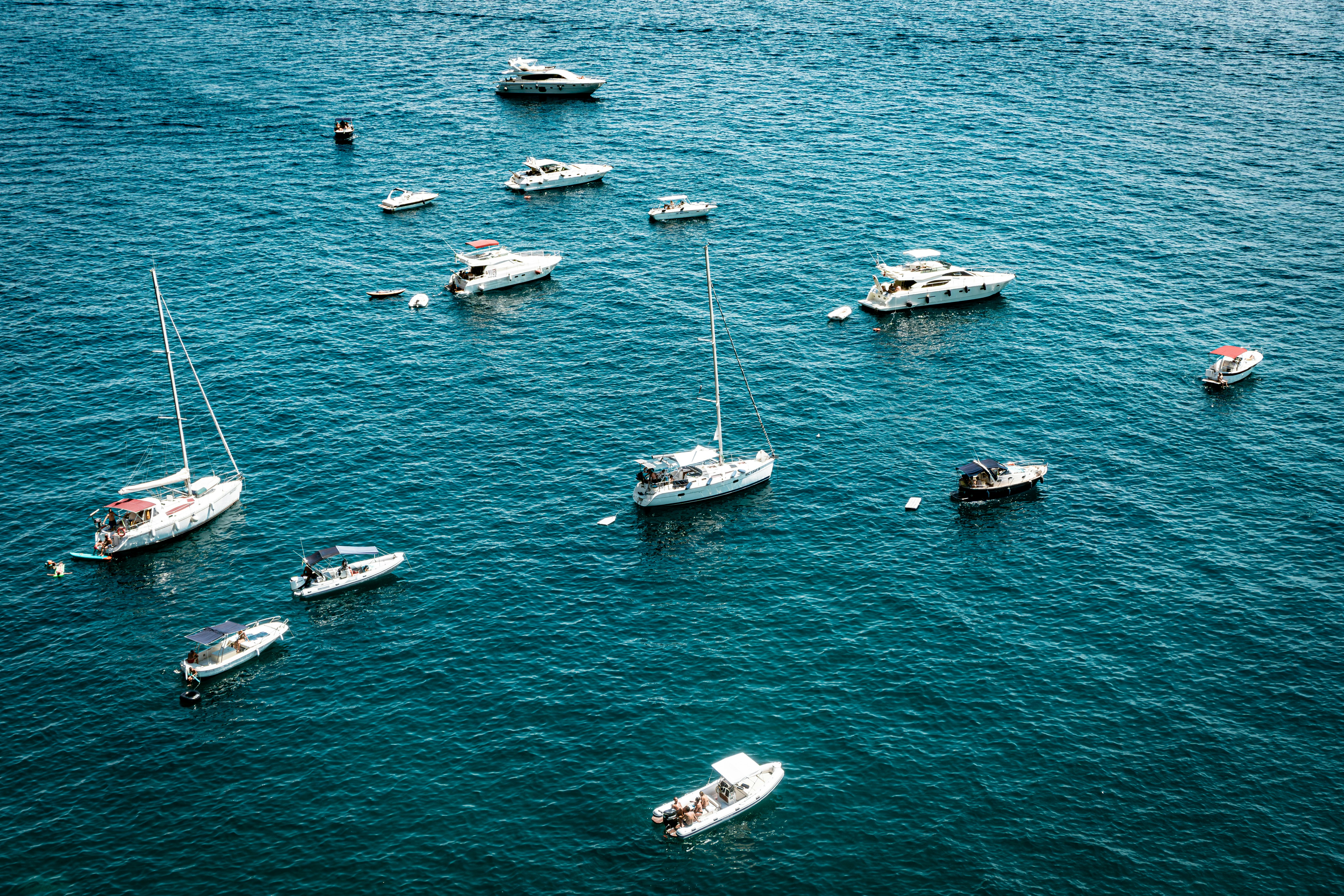 A group of boats floating on top of a body of water