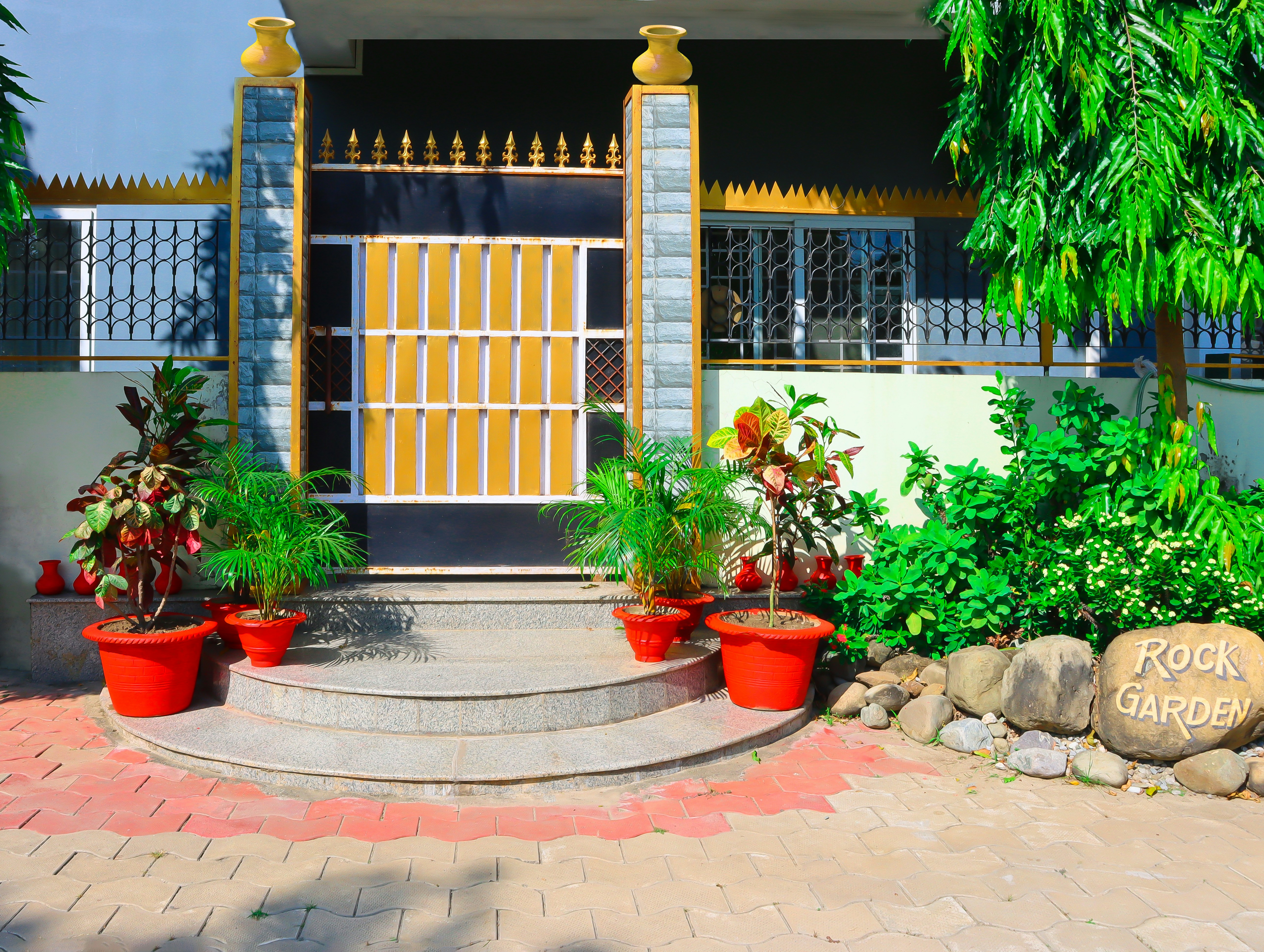 A house with a yellow door and some plants