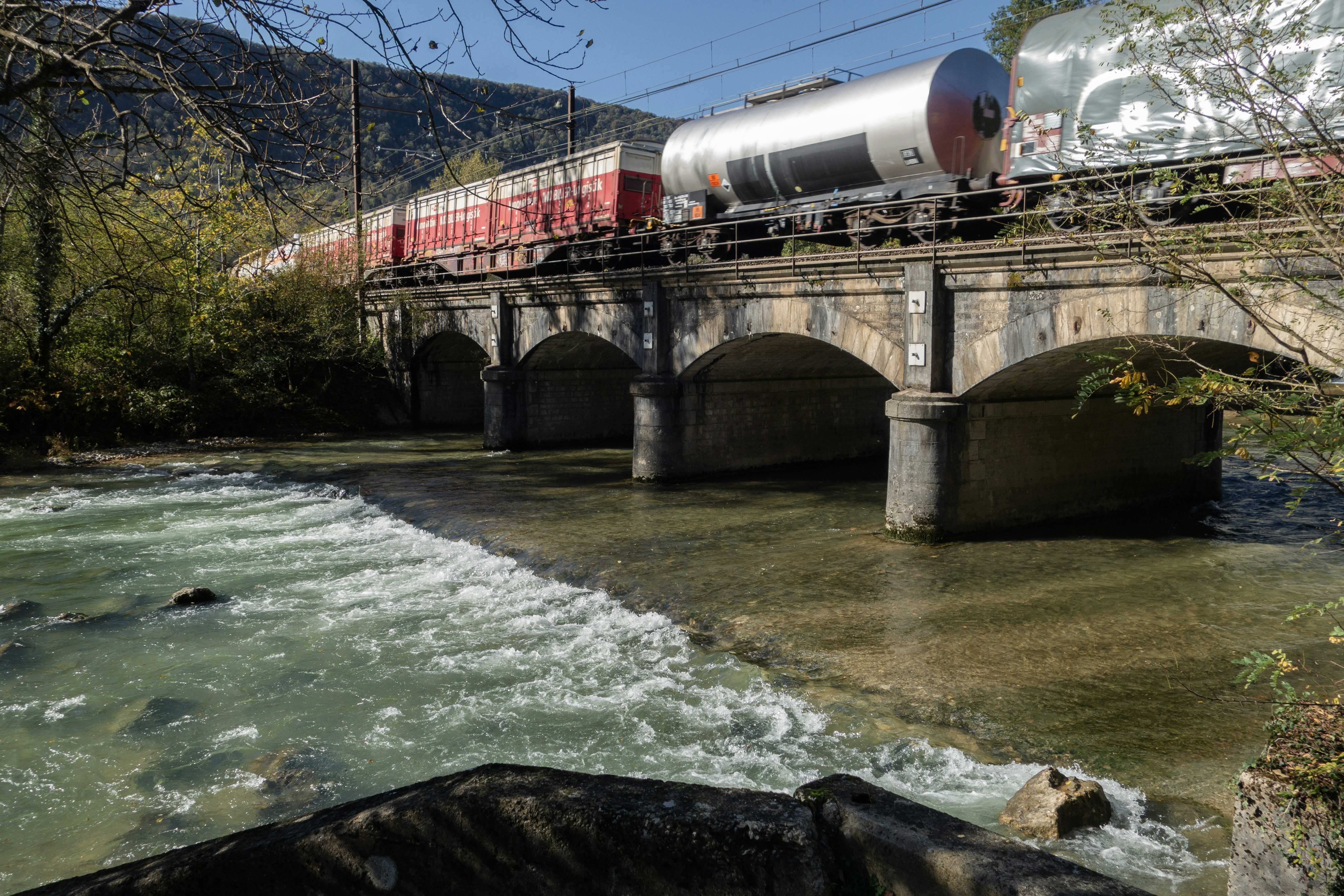 A train traveling over a bridge over a river