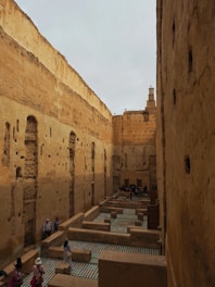 A group of people walking through a narrow alley way