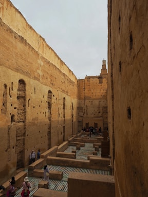 A group of people walking through a narrow alley way
