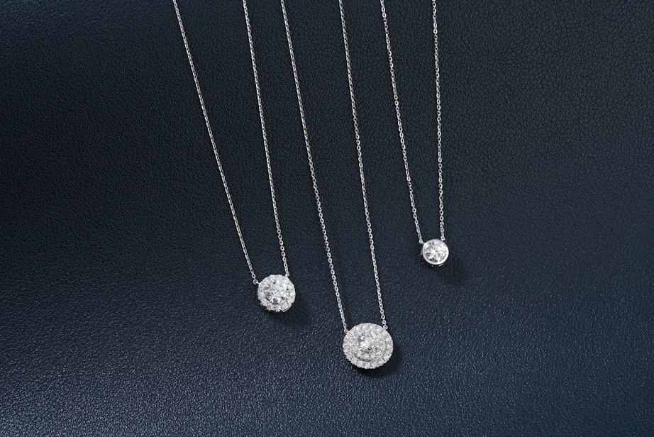 A group of three necklaces sitting on top of a table