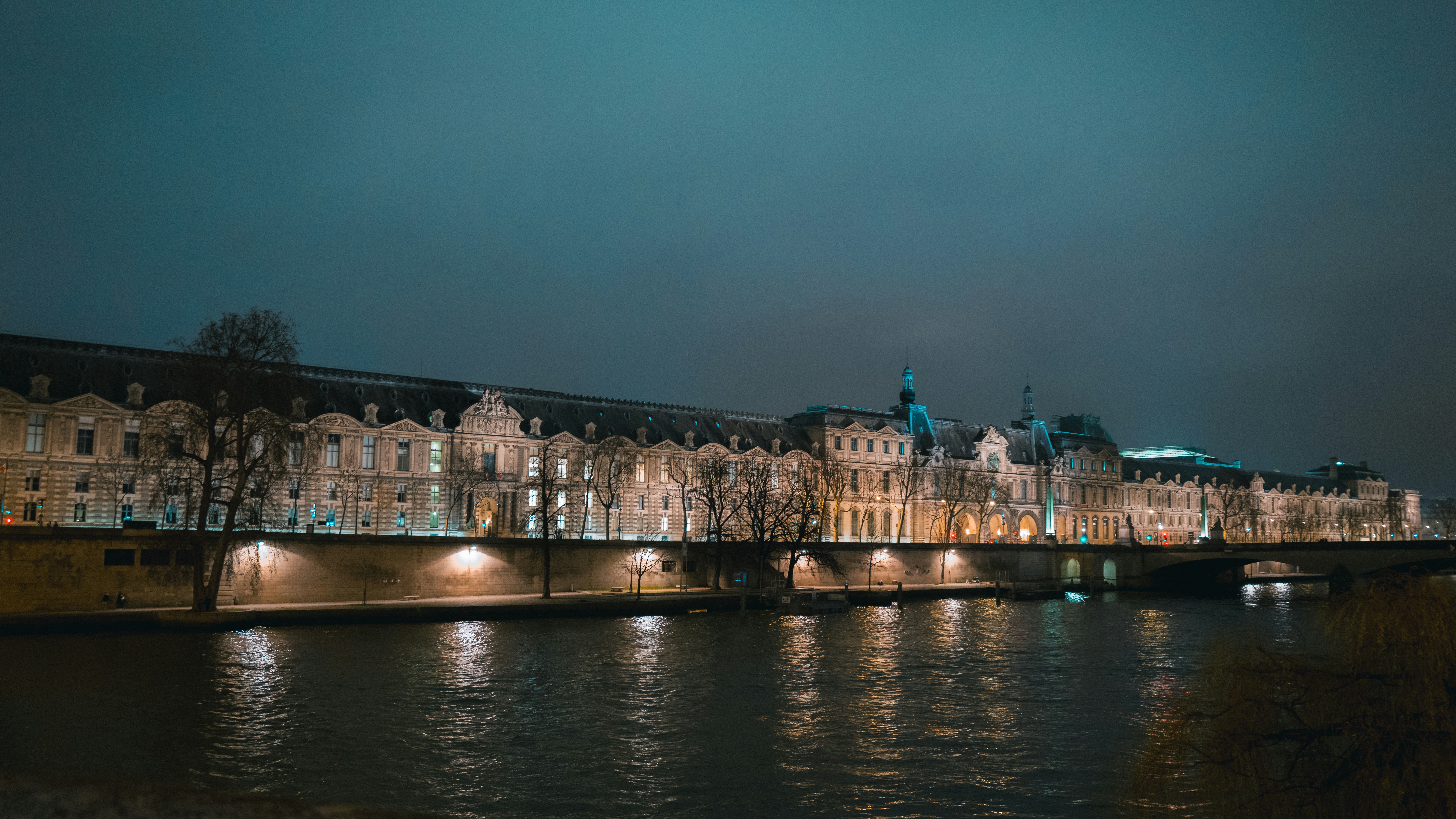 A bridge over a body of water at night