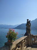 A balcony overlooking a body of water and mountains