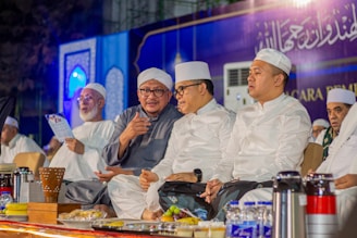 A group of men sitting next to each other